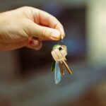 A hand holding keys to a home