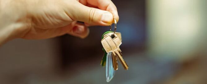 A hand holding keys to a home